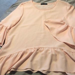 Pink Flowy shirt with ruffled details.